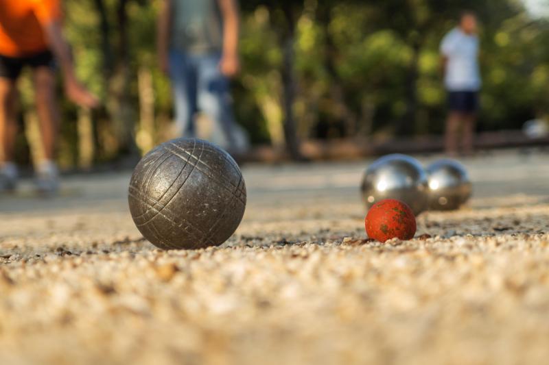 Close up view of bocce balls on a gravel course